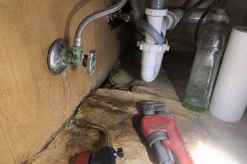 Corroded shutoff valve and supply line under a kitchen sink